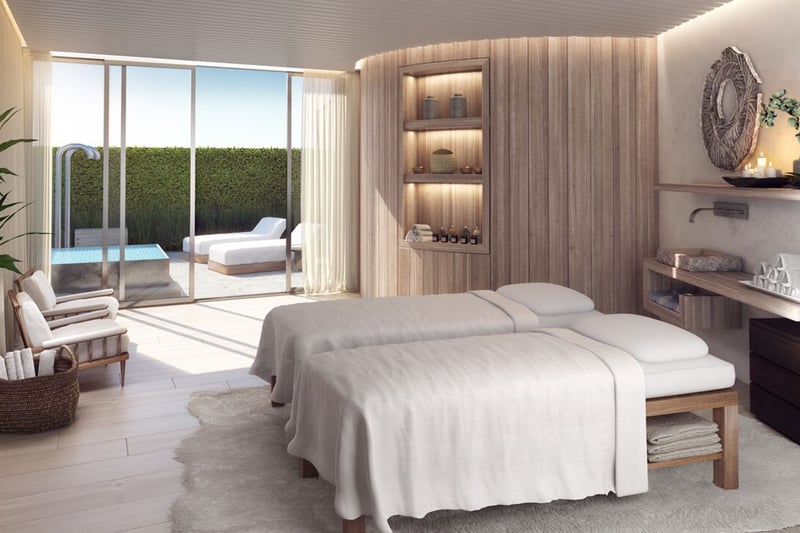 Auberge Beach Residences, Fort Lauderdale luxury and ultra luxury condos spa treatment room with dual massage beds, warm wood detailing, and soft daylight from the outdoor terrace.