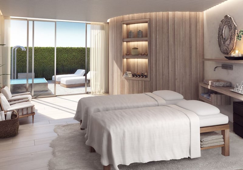 Auberge Beach Residences, Fort Lauderdale luxury and ultra luxury condos spa treatment room with dual massage beds, warm wood detailing, and soft daylight from the outdoor terrace.