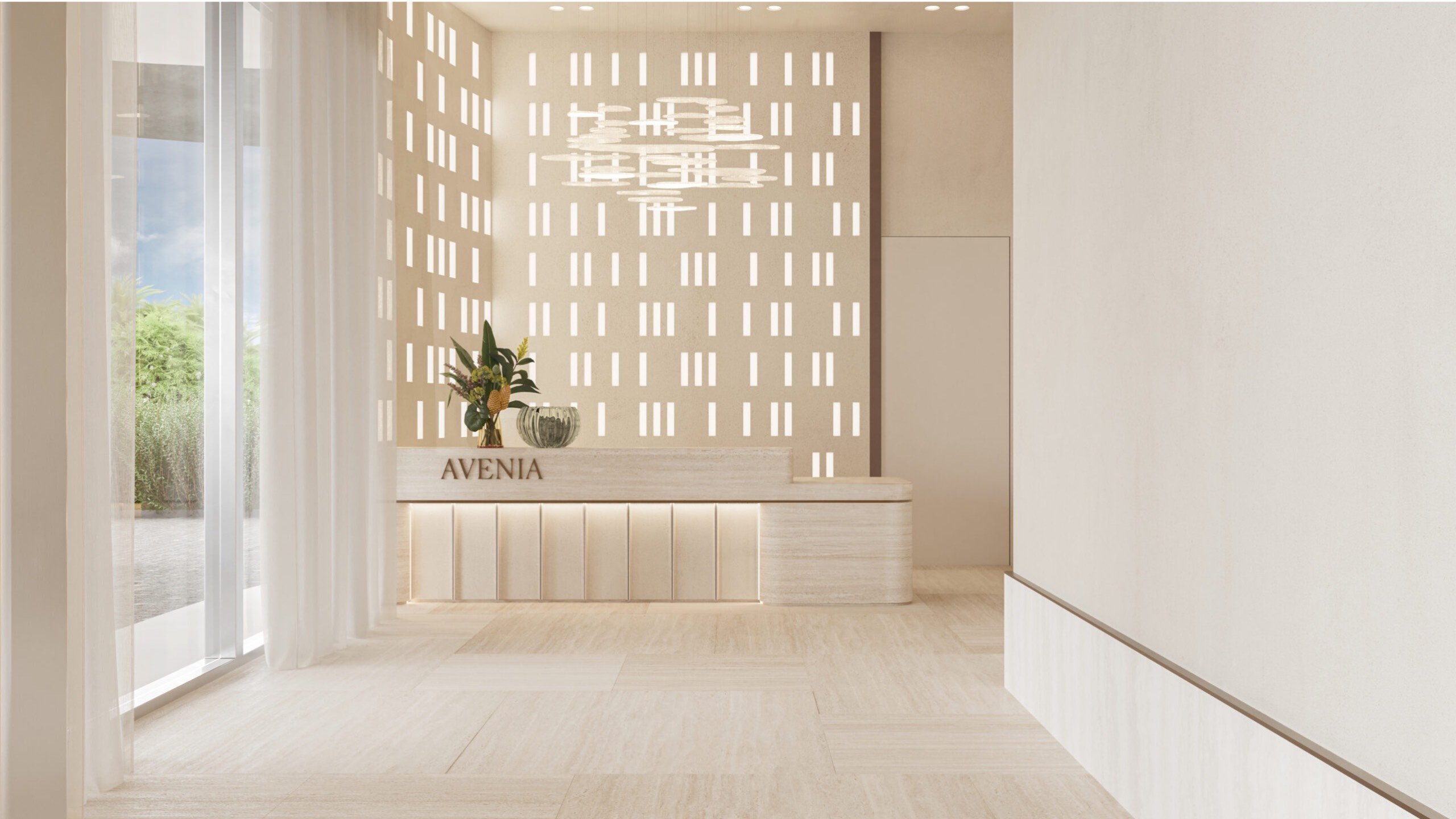 Avenia Aventura. A minimal, modern lobby with neutral tones, a plant on the reception desk labeled AVENIA, and patterned light filtering in.