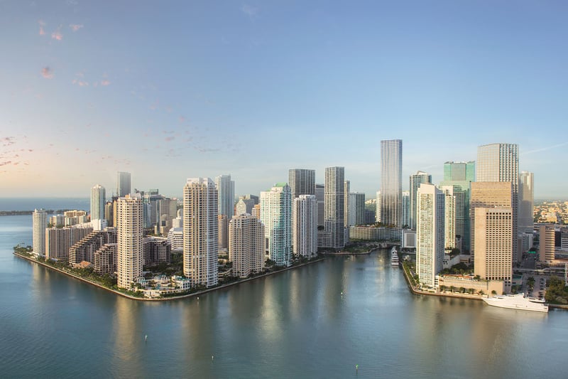 Baccarat Residences in Brickell, Miami, luxury and ultra luxury condos featuring a daylight aerial of the waterfront skyline, calm bay water, and high-rise towers.