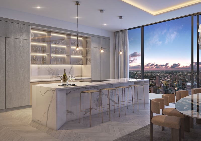 Baccarat Residences in Brickell, Miami, luxury and ultra luxury condos featuring a chef kitchen, marble island, glass cabinetry, dining area, and expansive skyline views.