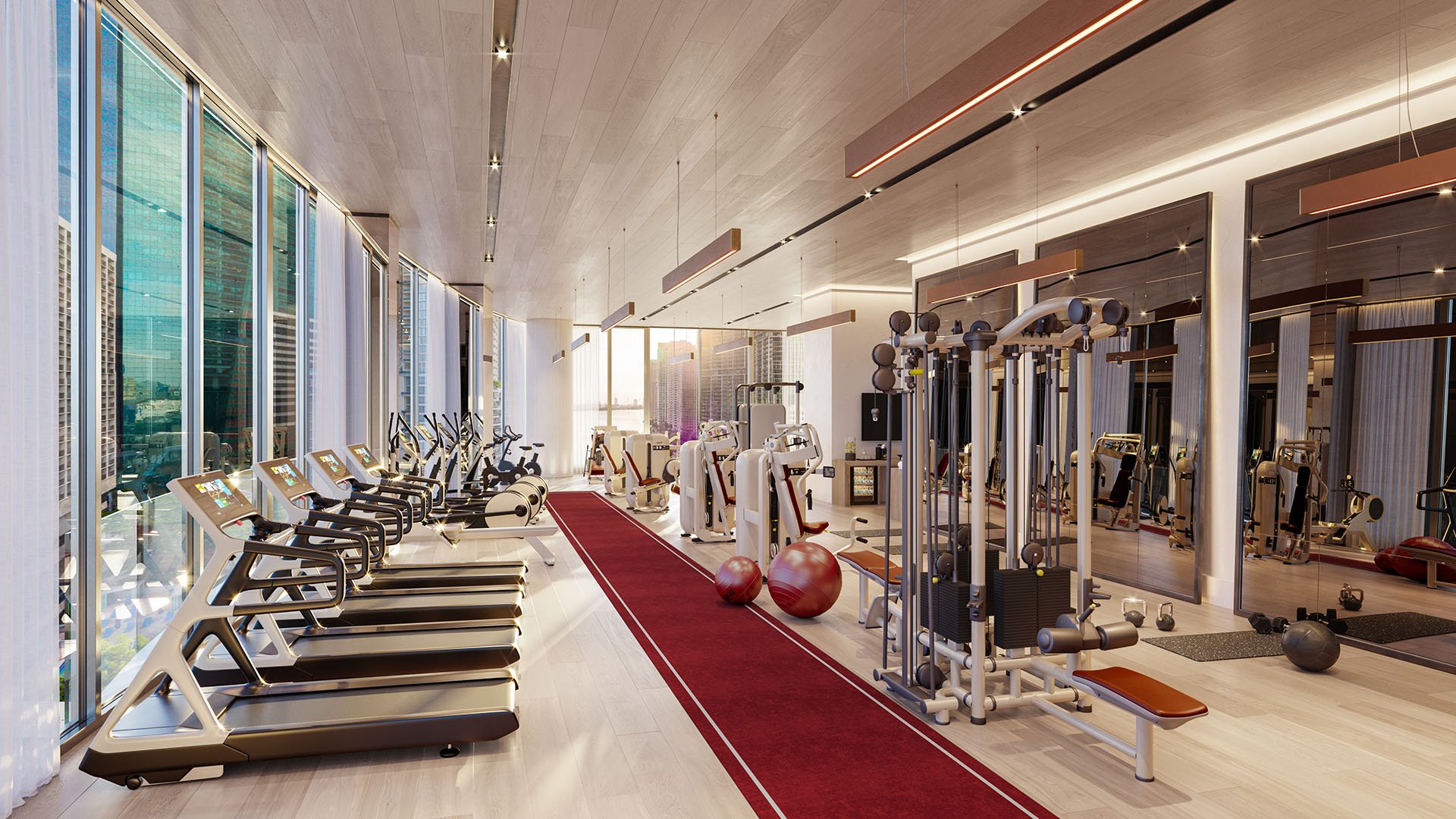 Baccarat Residences in Brickell, Miami, luxury and ultra luxury condos featuring a fitness center with treadmills, strength machines, mirrored walls, and floor-to-ceiling city-facing windows.