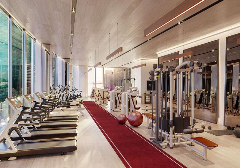 Baccarat Residences in Brickell, Miami, luxury and ultra luxury condos featuring a fitness center with treadmills, strength machines, mirrored walls, and floor-to-ceiling city-facing windows.