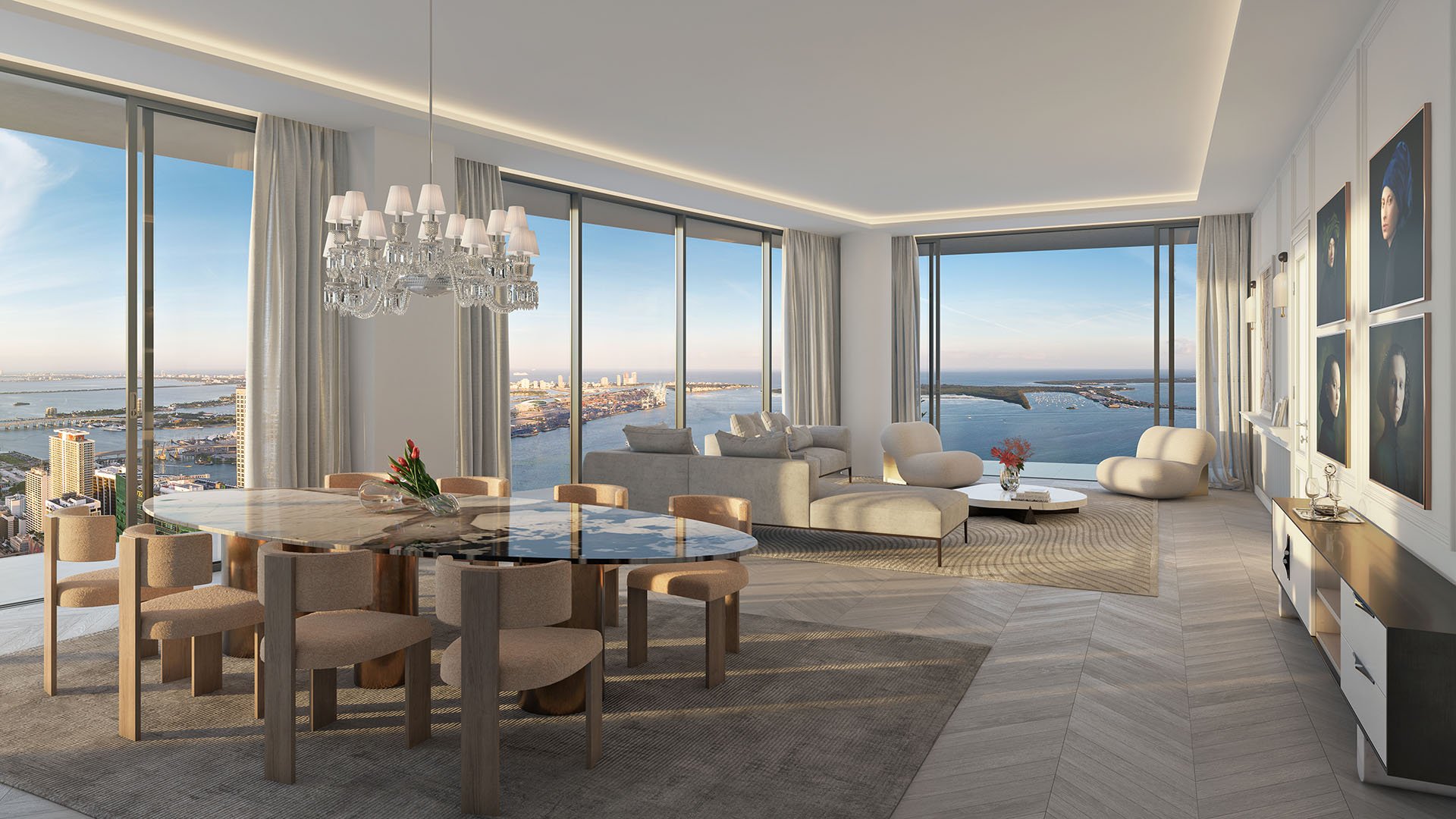 Baccarat Residences in Brickell, Miami, luxury and ultra luxury condos featuring an open-concept living and dining room, corner windows, a chandelier, an art wall, and sweeping waterfront views.