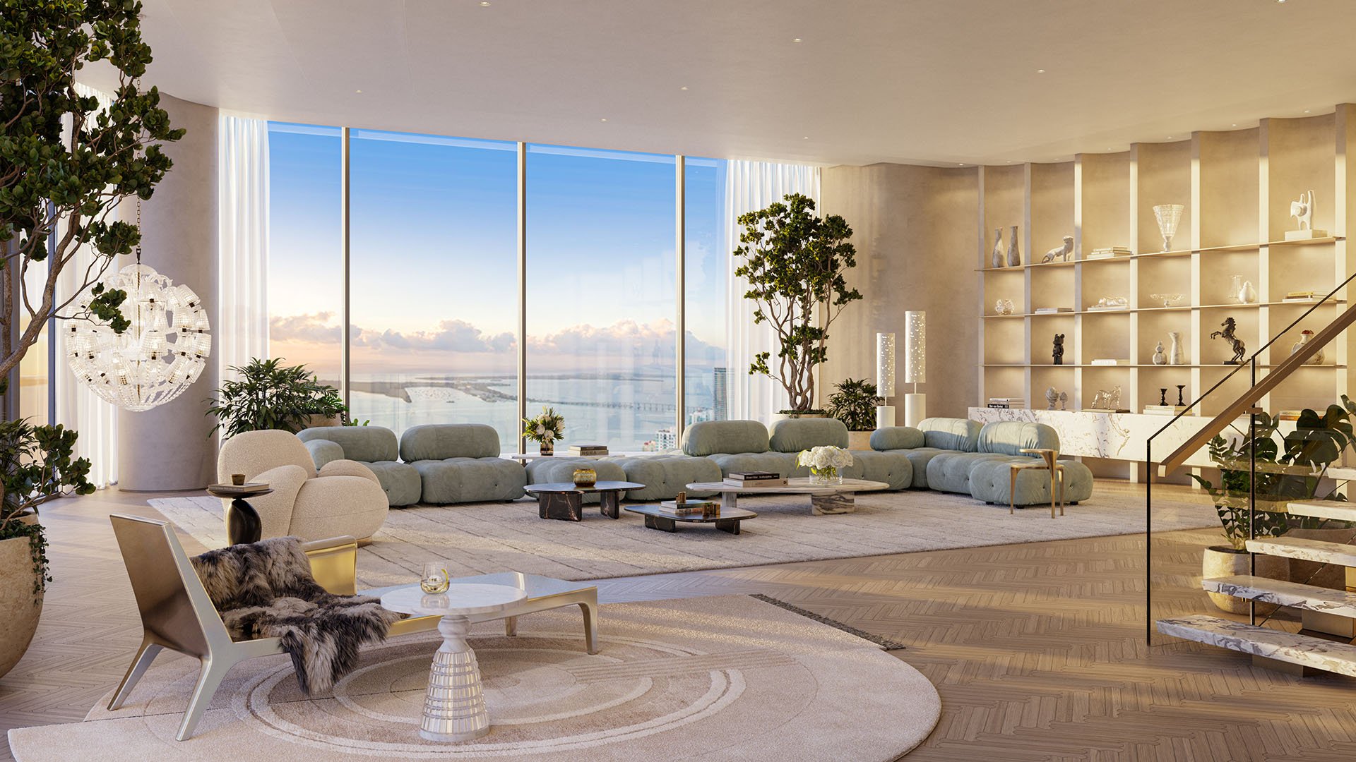 Baccarat Residences in Brickell, Miami, luxury and ultra luxury condos featuring a penthouse great room, custom shelving, expansive sectional seating, sculptural lighting, and panoramic water views.