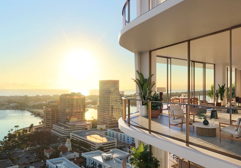 Sunset view from a curved glass balcony looking into an elegant residence at Banyan Tree Residences in West Palm Beach, featuring luxury and ultra luxury condos with dramatic waterfront exposure and expansive outdoor living space.