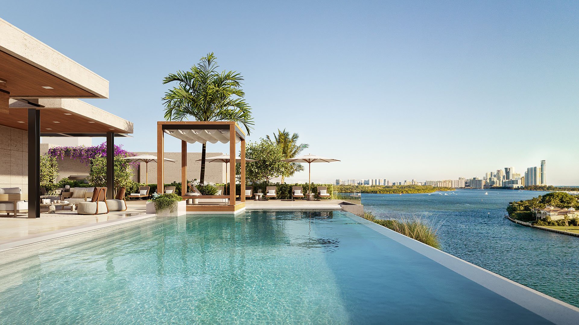 Infinity-edge pool at Bay Harbor Towers, Bay Harbor Islands, Florida with sun loungers, cabana and panoramic waterway and Miami skyline views, featuring luxury and ultra luxury preconstruction condos.