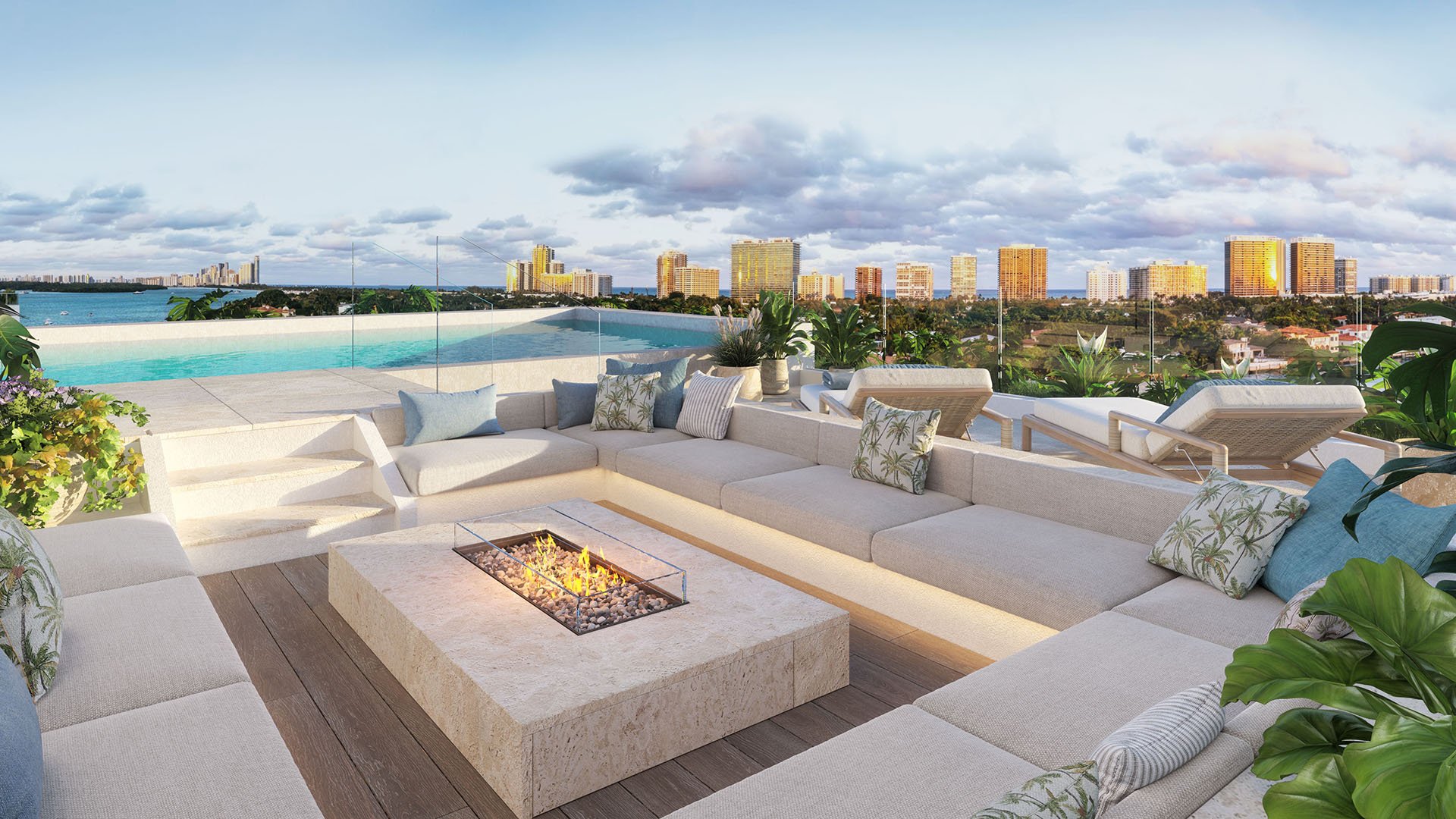 Bay Harbor Towers Bay Harbor Islands, Florida rooftop lounge with fire pit seating, sunbeds and infinity pool overlooking city skyline, showcasing luxury and ultra luxury preconstruction condos amenities.