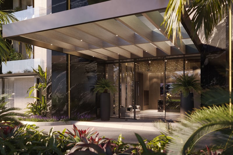 Bay Harbor Towers Bay Harbor Islands, Florida porte-cochere entrance with marble façade, glass doors, wood ceiling and lush landscaping, highlighting luxury and ultra luxury preconstruction condos arrival experience.