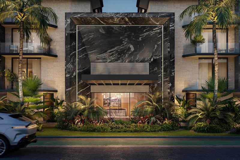Night view of Bay Harbor Towers in Bay Harbor Islands, Florida featuring dramatic marble entry portal, illuminated balconies, palm landscaping and street arrival, showcasing luxury and ultra luxury preconstruction condos.