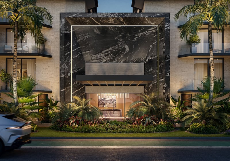 Night view of Bay Harbor Towers in Bay Harbor Islands, Florida featuring dramatic marble entry portal, illuminated balconies, palm landscaping and street arrival, showcasing luxury and ultra luxury preconstruction condos.
