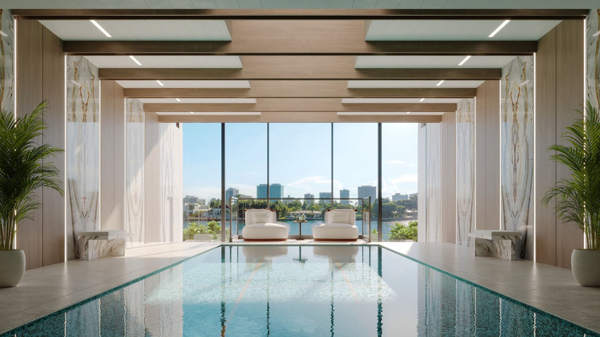Bay Harbor Towers, Bay Harbor Islands, Florida indoor lap pool with spa seating, marble accents and expansive window views to the waterfront, showcasing luxury and ultra luxury preconstruction condos amenities.