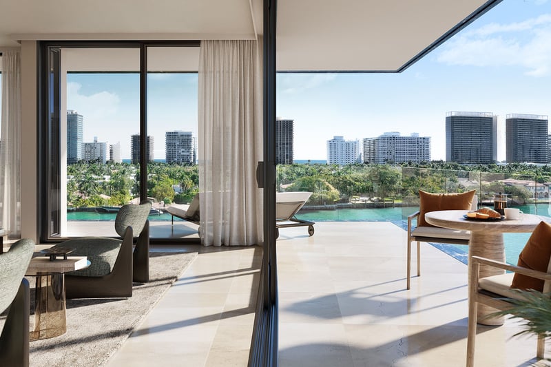 Bay Harbor Towers Bay Harbor Islands waterfront living room and terrace with lounge seating, glass railing and canal-to-ocean skyline views, highlighting luxury and ultra luxury preconstruction condos in Miami.