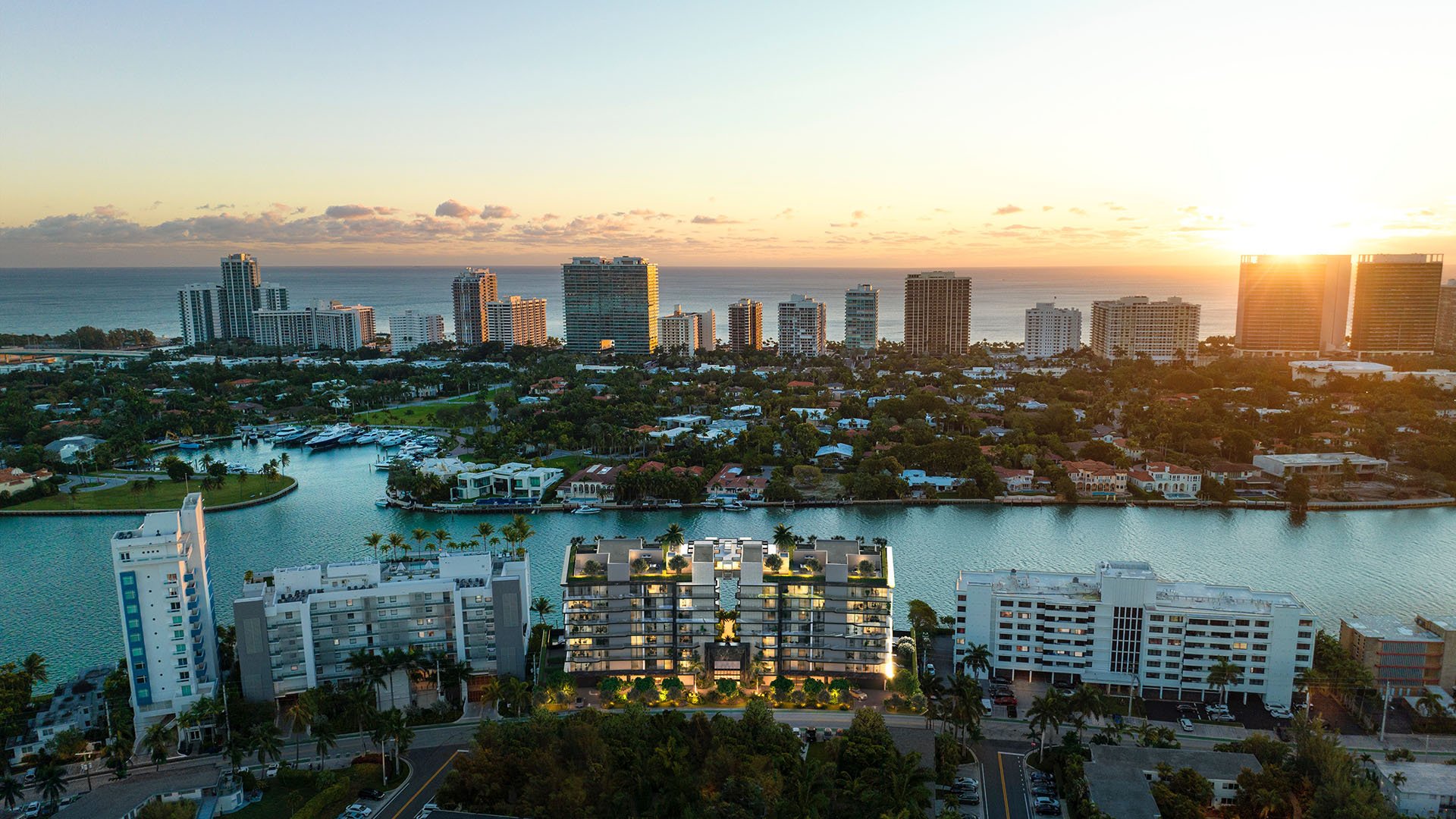 Sunset aerial of Bay Harbor Towers in Bay Harbor Islands Miami, showcasing luxury and ultra luxury preconstruction condos along the Intracoastal Waterway with glowing skyline, waterways, and Atlantic Ocean horizon.