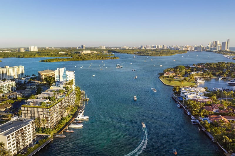 Aerial view of Bay Harbor Towers Bay Harbor Islands Miami on the Intracoastal Waterway, showcasing luxury and ultra luxury preconstruction condos with boats, islands, and sweeping waterfront skyline vistas.