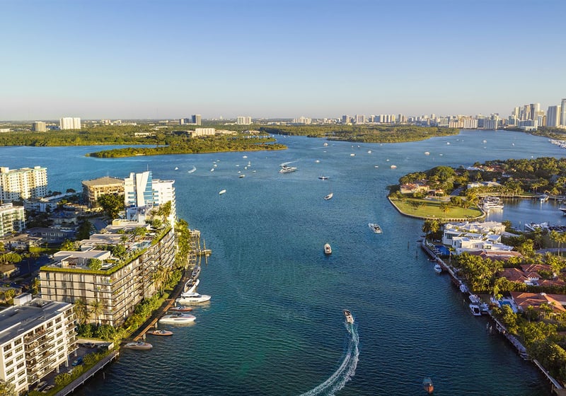 Aerial view of Bay Harbor Towers Bay Harbor Islands Miami on the Intracoastal Waterway, showcasing luxury and ultra luxury preconstruction condos with boats, islands, and sweeping waterfront skyline vistas.