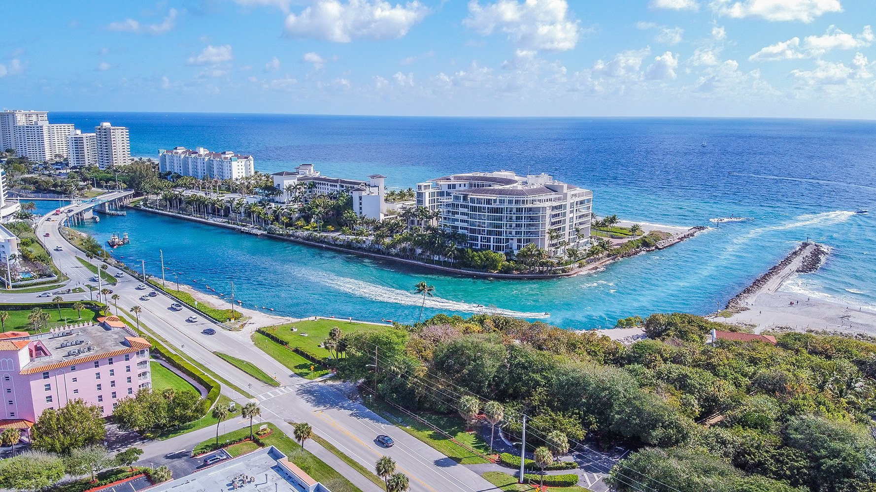 Boca Raton, South Florida marina and residential coastline seen from above, surrounded by palm-lined neighborhoods and luxury condos; ultra luxury, preconstruction and resale opportunities. Featuring coastal, aerial, view, and area.
