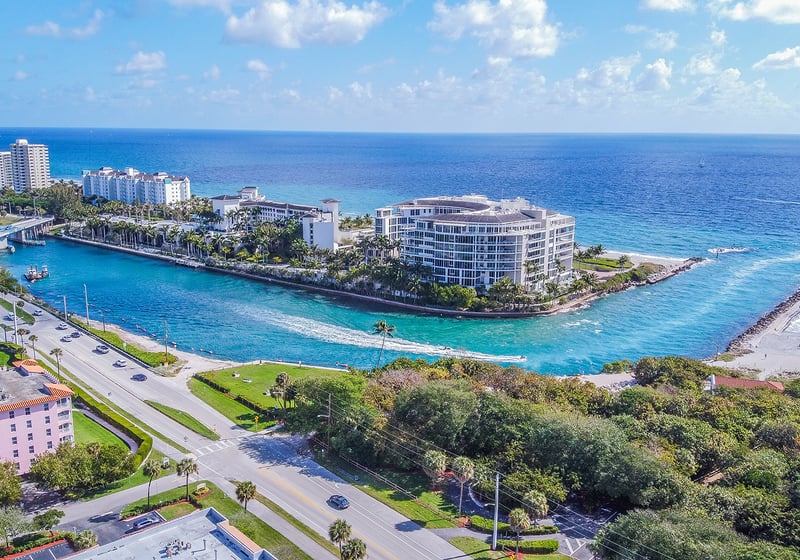 Boca Raton, South Florida marina and residential coastline seen from above, surrounded by palm-lined neighborhoods and luxury condos; ultra luxury, preconstruction and resale opportunities.