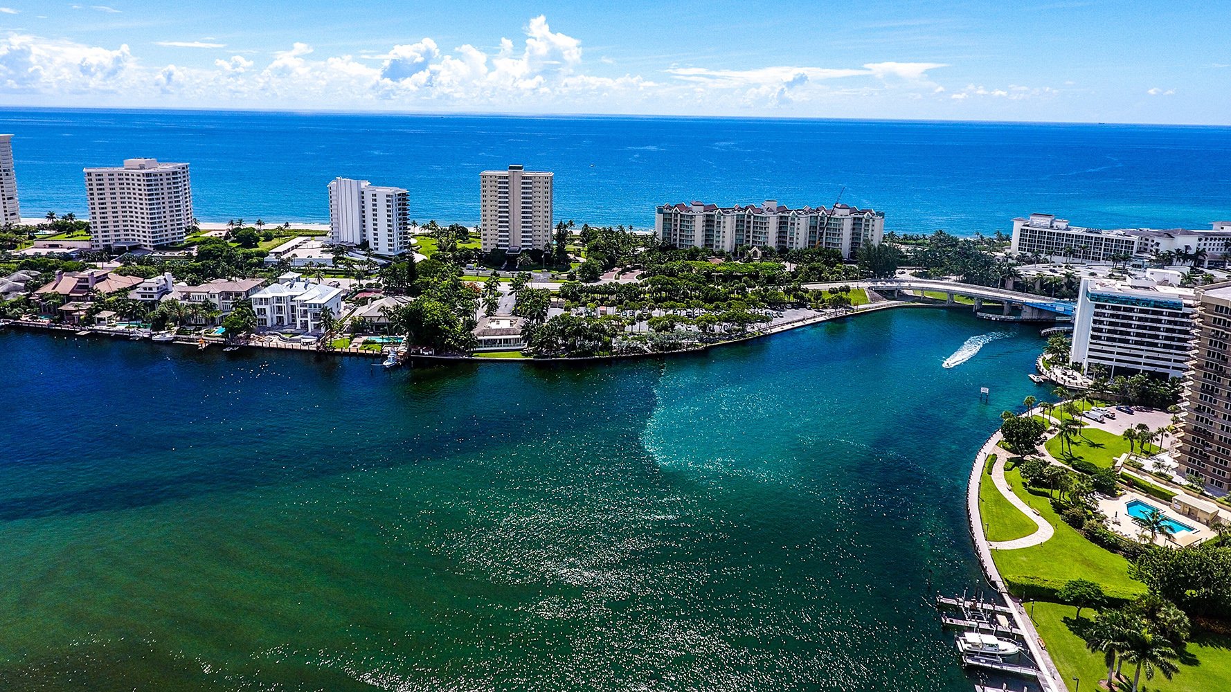 Boca Raton cityscape from the coast, high-rises and greenery along the Intracoastal—luxury and ultra luxury condos with preconstruction and resale options.