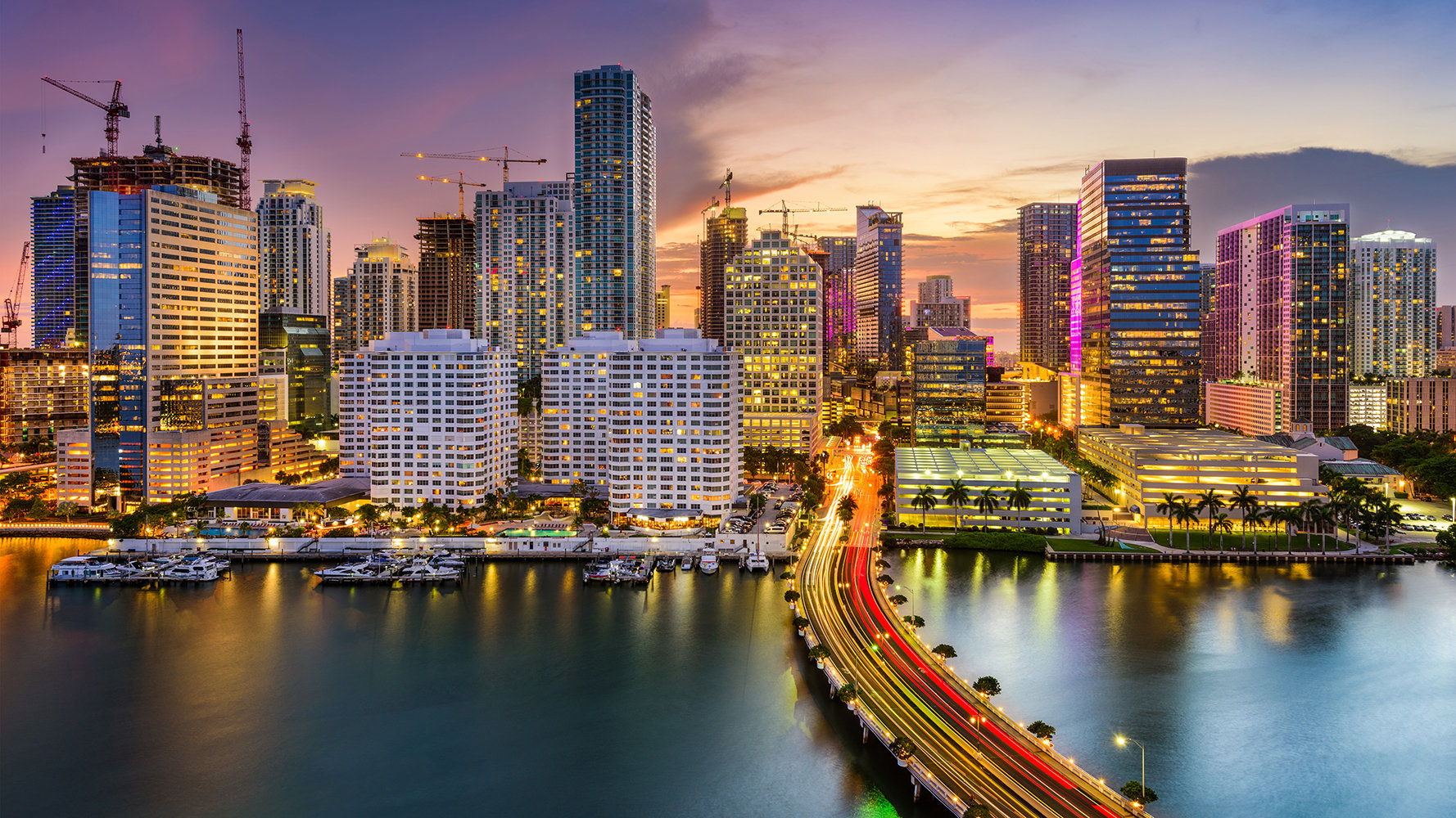 Brickell, Miami skyline at sunset over Biscayne Bay; luxury and ultra luxury condos, preconstruction living in the Brickell waterfront district.