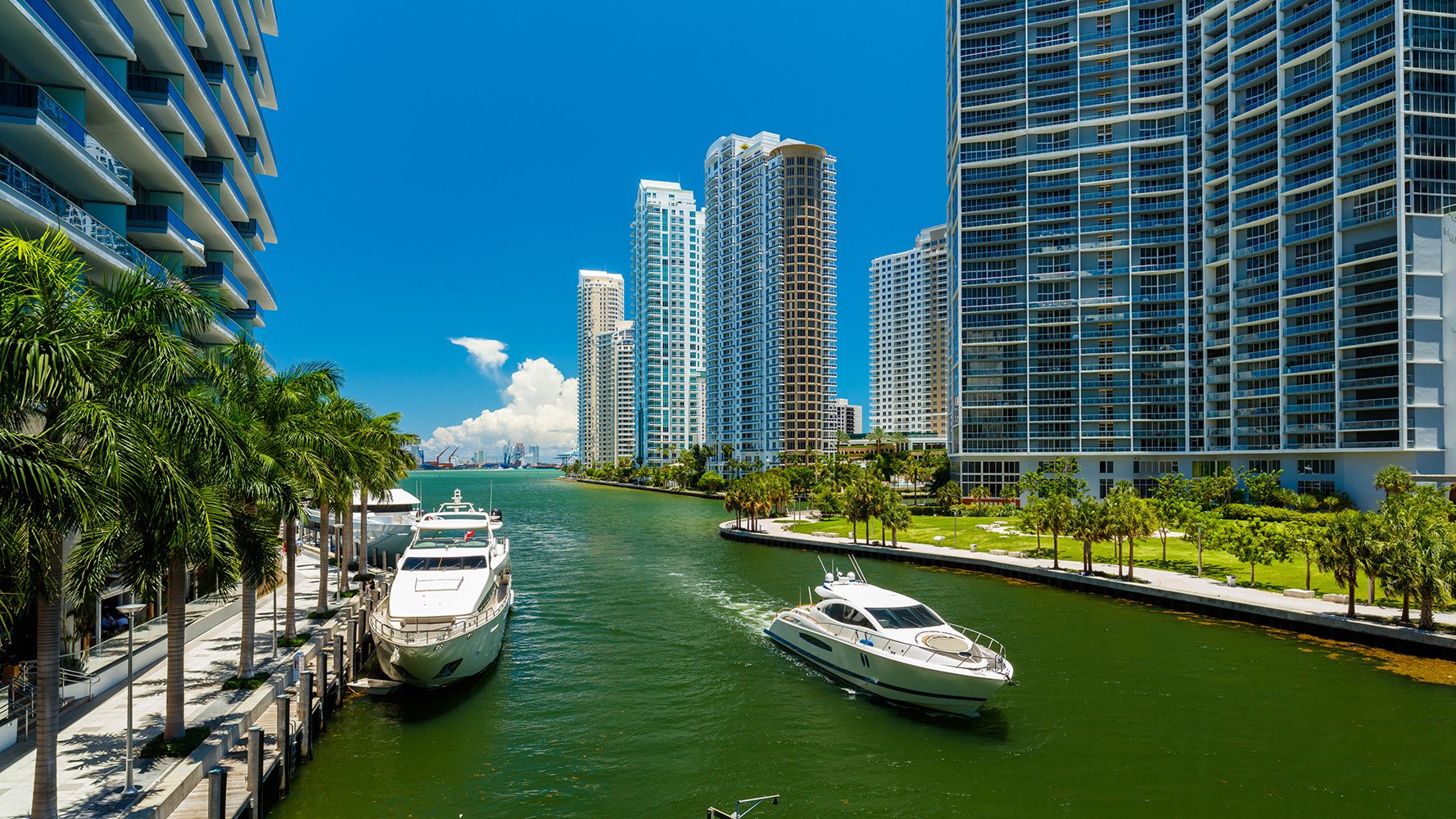 Brickell waterfront high‑rises with boats along Biscayne Bay—signature Miami zone for luxury and ultra luxury condos, preconstruction and resale.