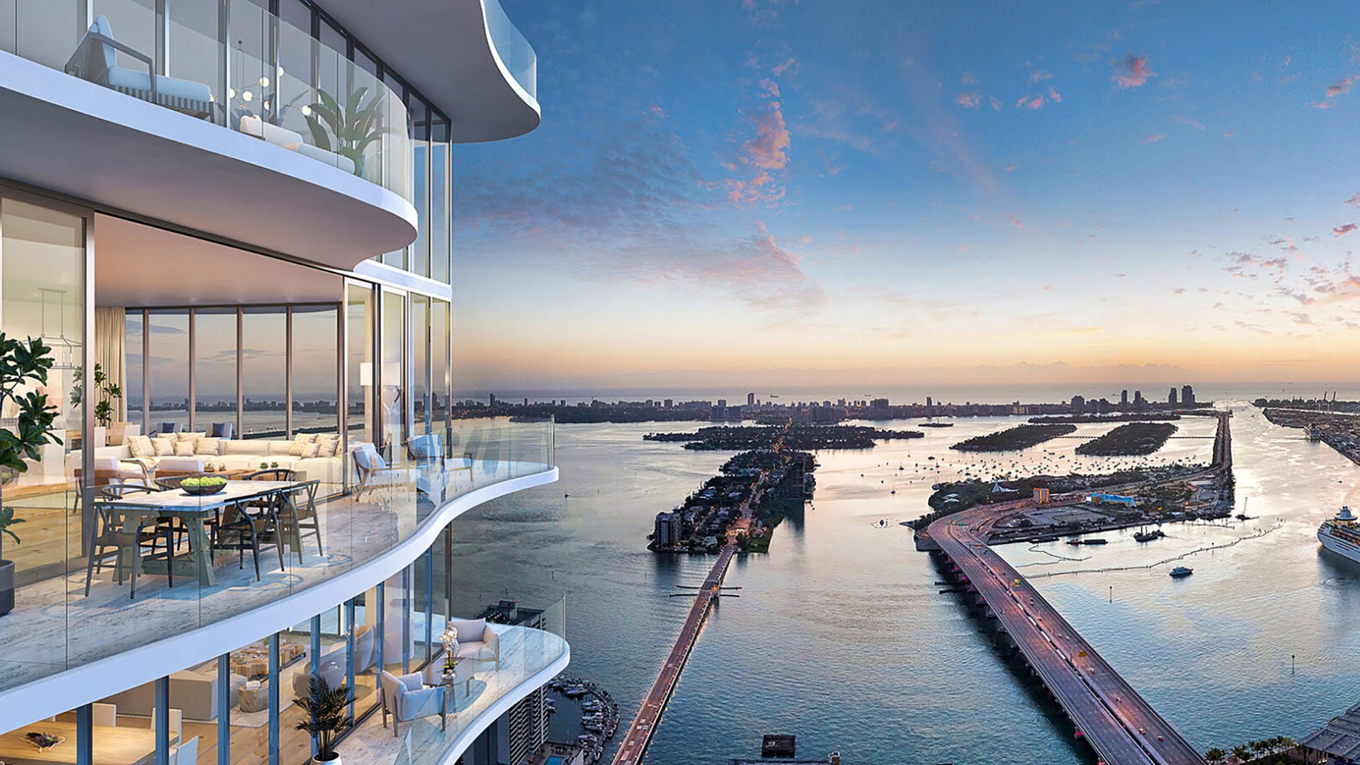 Casa Bella Downtown Miami waterfront sunset view from curved glass balcony and dining terrace above Biscayne Bay and causeways, highlighting luxury and ultra luxury preconstruction condos with resort-style living.