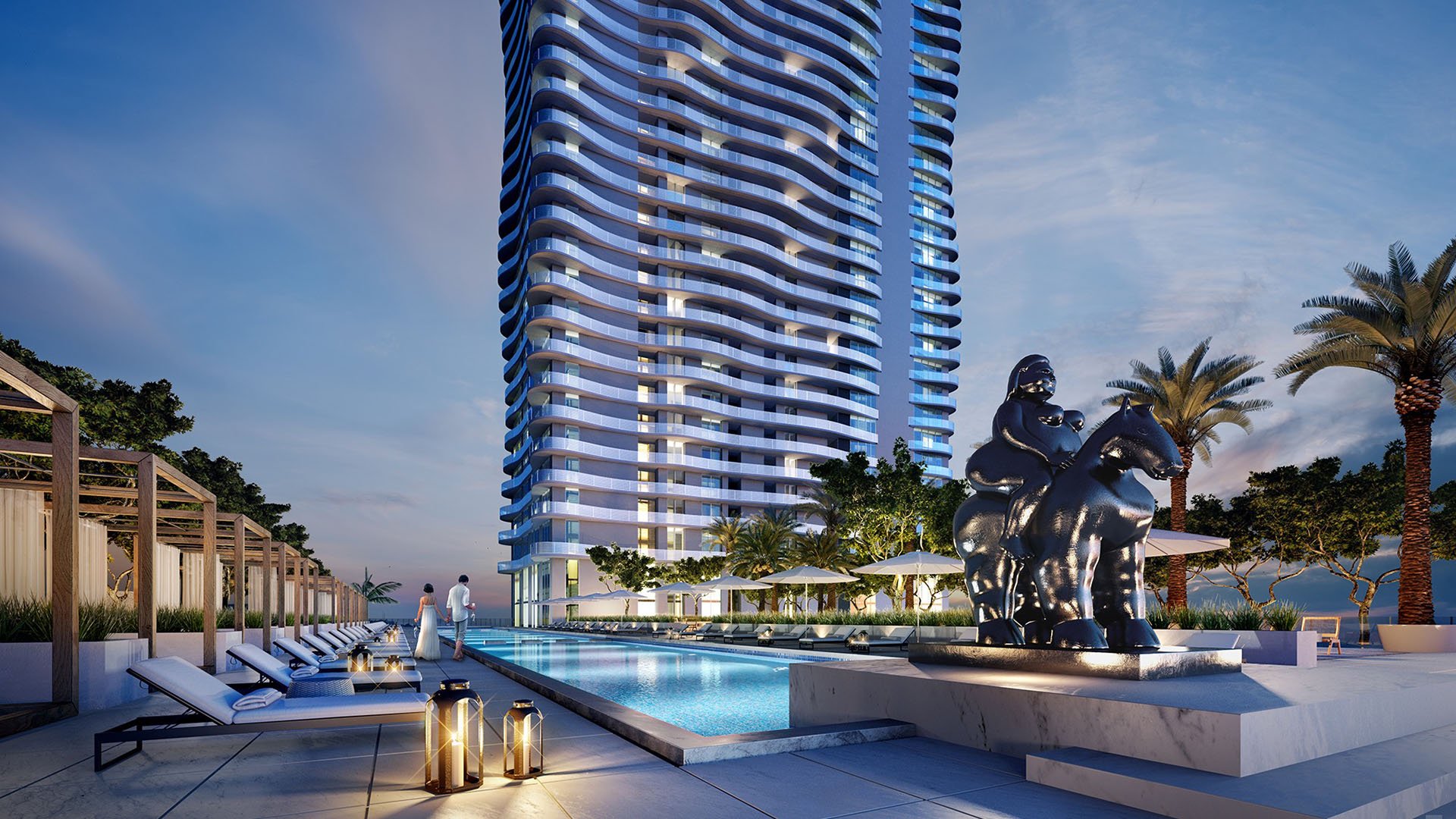 Casa Bella Downtown Miami evening pool deck with cabanas, loungers and sculptural art beside the tower, showcasing luxury and ultra luxury preconstruction condos amenities in Downtown Miami.