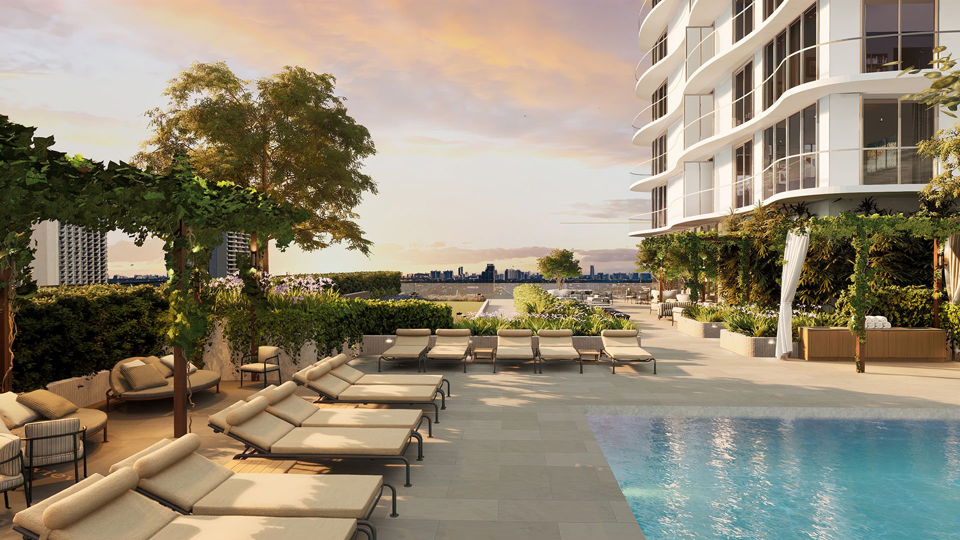 Casa Bella Downtown Miami sunset poolside terrace with loungers, pergola seating and landscaped gardens, showcasing luxury and ultra luxury preconstruction condos amenities with bay views in Downtown Miami.