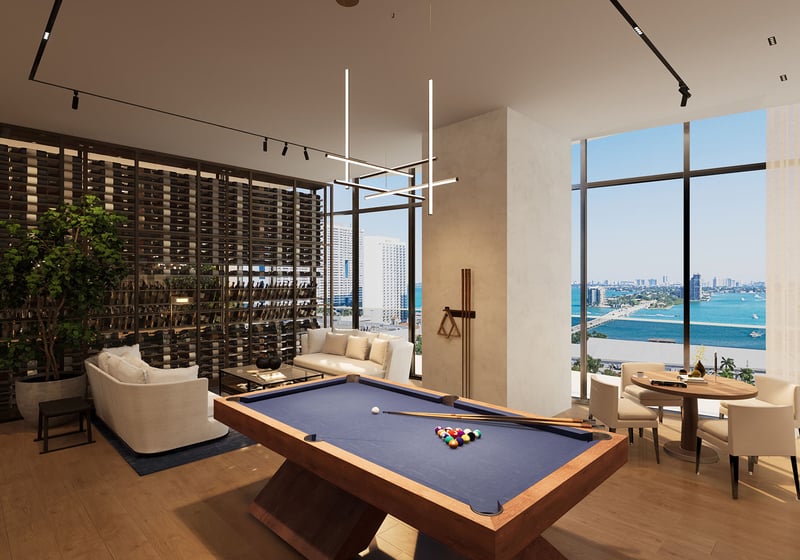 Casa Bella by B&B Italia Downtown Miami game lounge with pool table, wine display wall and seating, set against panoramic Biscayne Bay and skyline views, showcasing luxury and ultra luxury preconstruction condos amenities.