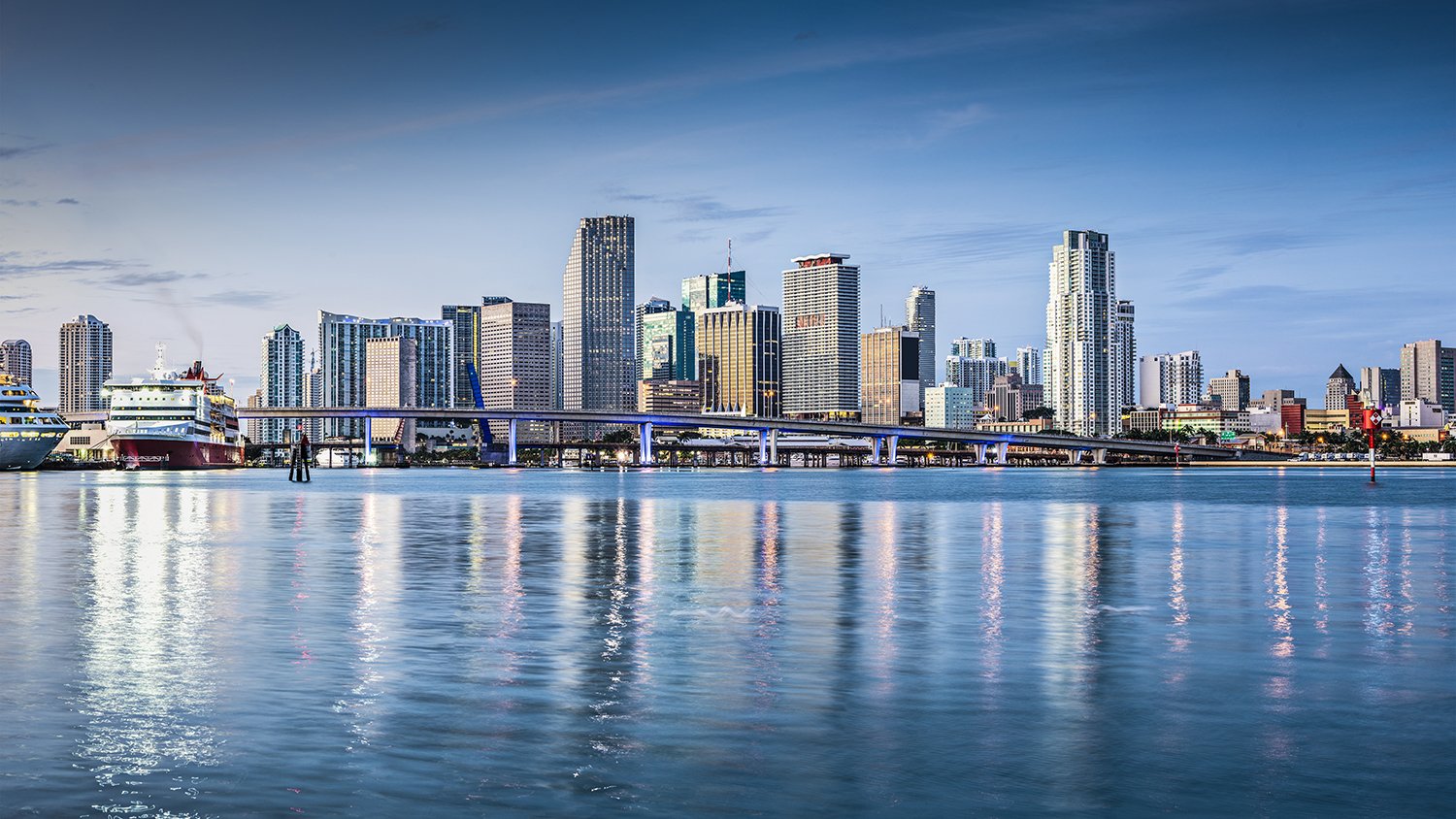 Miami waterfront cityscape at sunset; luxury and ultra luxury condos along the bay, preconstruction options across Miami’s prime districts.