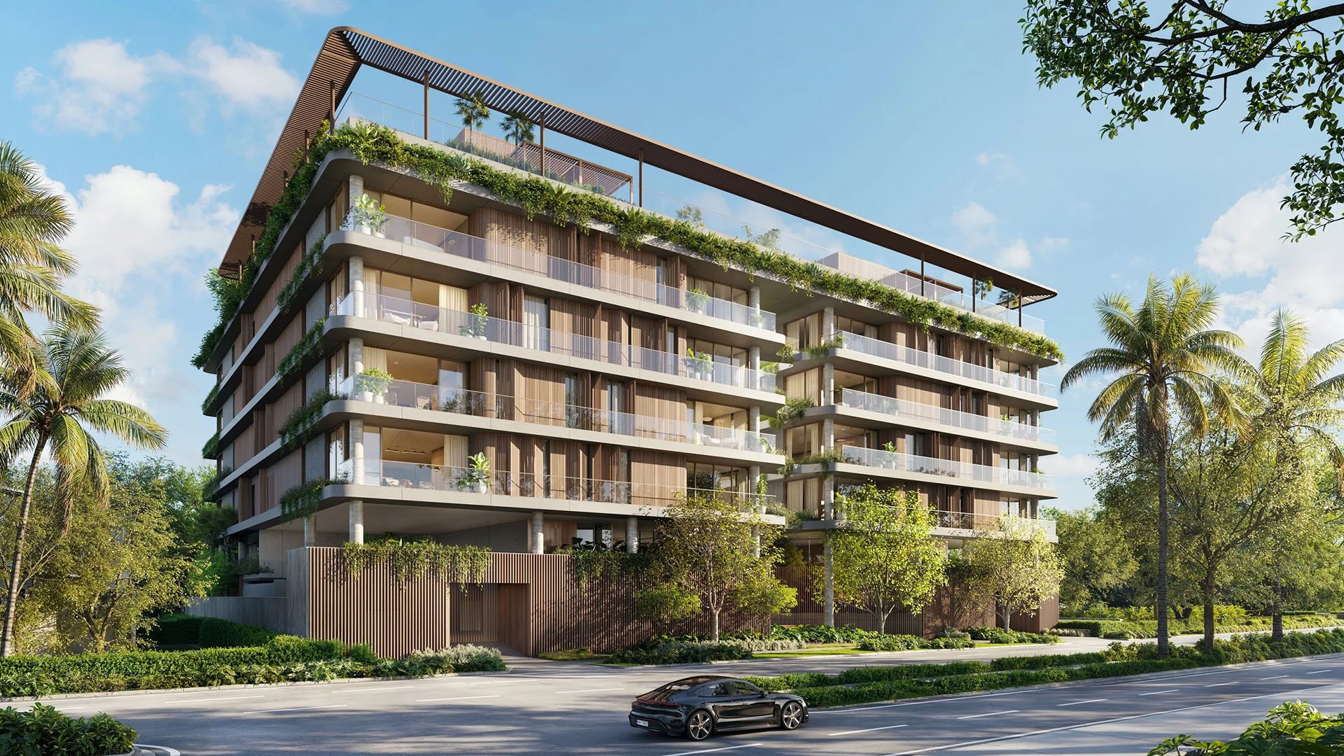 Colette Residences in Brickell luxury ultra luxury condos with a palm-lined curved corner exterior, wraparound glass balconies, and lush planted terraces along the street.