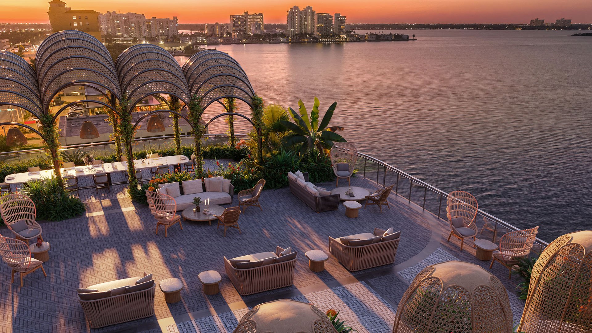Sunset garden lounge with pergola arches, waterfront seating, and open bay views at Continuum Club and Residences in North Bay Village, a preconstruction luxury and ultra luxury condos development with elevated outdoor social space.