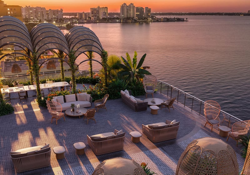 Sunset garden lounge with pergola arches, waterfront seating, and open bay views at Continuum Club and Residences in North Bay Village, a preconstruction luxury and ultra luxury condos development with elevated outdoor social space.
