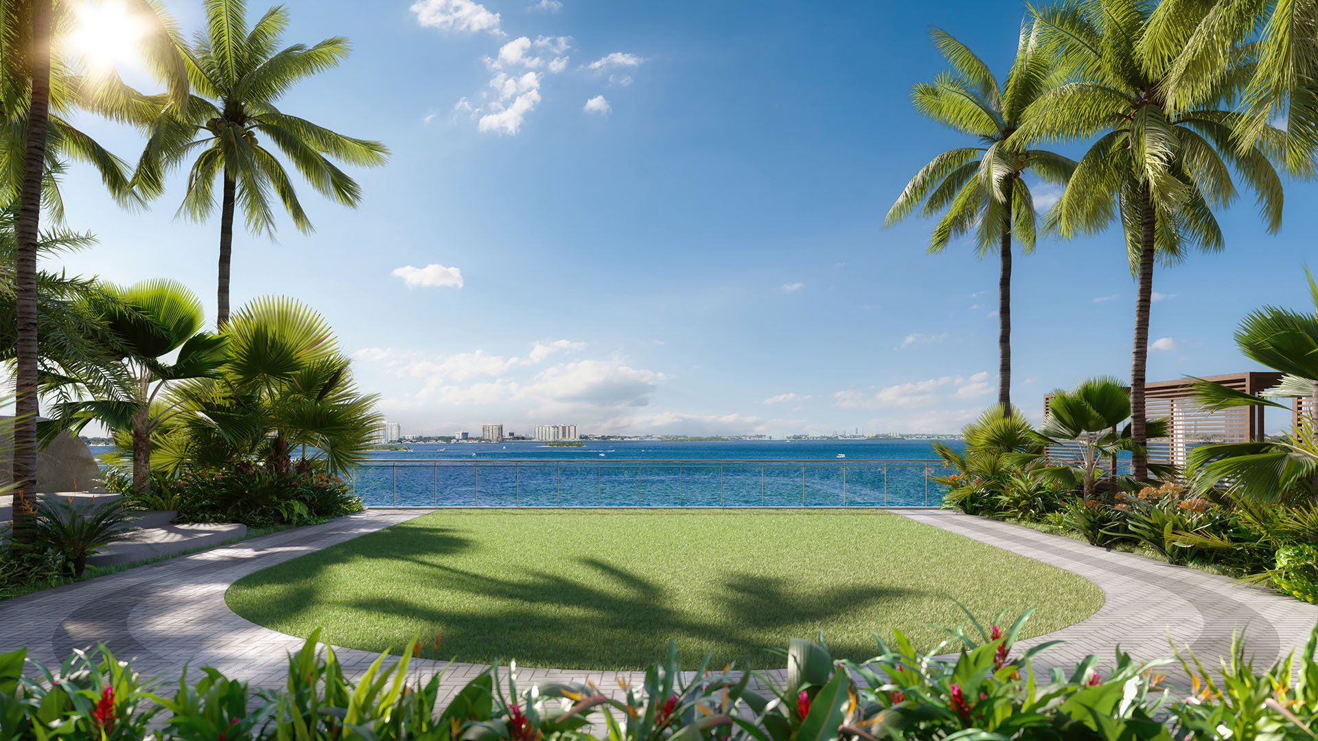 Circular fitness lawn framed by palm trees and bay views at Continuum Club and Residences in North Bay Village, a preconstruction luxury and ultra luxury condos development with landscaped outdoor wellness amenities.