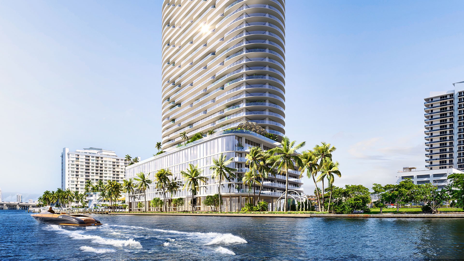 Waterfront exterior of the curved condo tower with a speedboat on the bay at Continuum Club and Residences in North Bay Village, a preconstruction luxury and ultra luxury condos development with a prominent marina-facing presence.