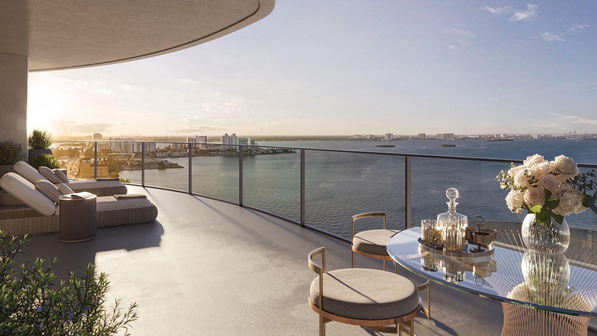 Wraparound sunrise terrace with lounge seating, dining table, and wide bay views at Continuum Club and Residences in North Bay Village, a preconstruction luxury and ultra luxury condos development with expansive outdoor living space.