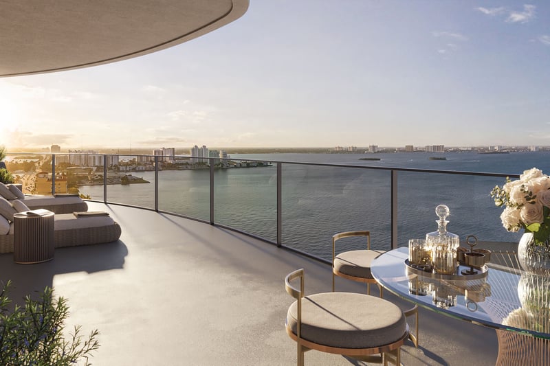 Wraparound sunrise terrace with lounge seating, dining table, and wide bay views at Continuum Club and Residences in North Bay Village, a preconstruction luxury and ultra luxury condos development with expansive outdoor living space.
