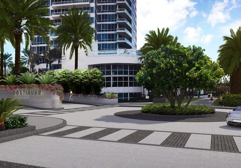Arrival motor court and monument sign at Continuum on South Beach, Miami Beach, Florida, introducing luxury and ultra luxury condos with tropical landscaping, a circular drive, and the tower base in view.