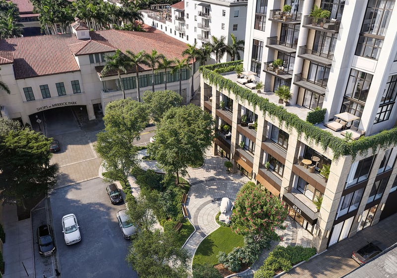 Aerial view of the landscaped courtyard, circular garden, and terraced condo facade at Cora Merrick Park in Coral Gables, highlighting luxury and ultra luxury condos with lush terraces and a pedestrian-focused arrival experience.