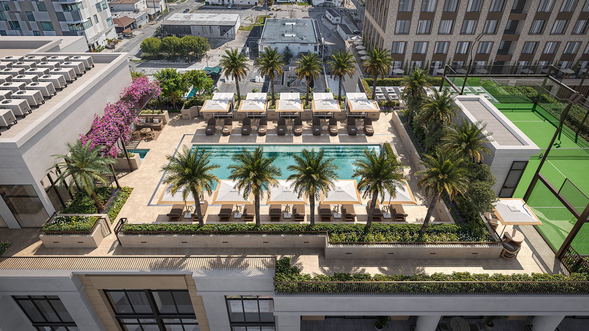 Aerial rooftop amenity deck at Cora Merrick Park in Coral Gables featuring a pool, cabanas, palm landscaping, and adjacent padel court for luxury and ultra luxury condos.