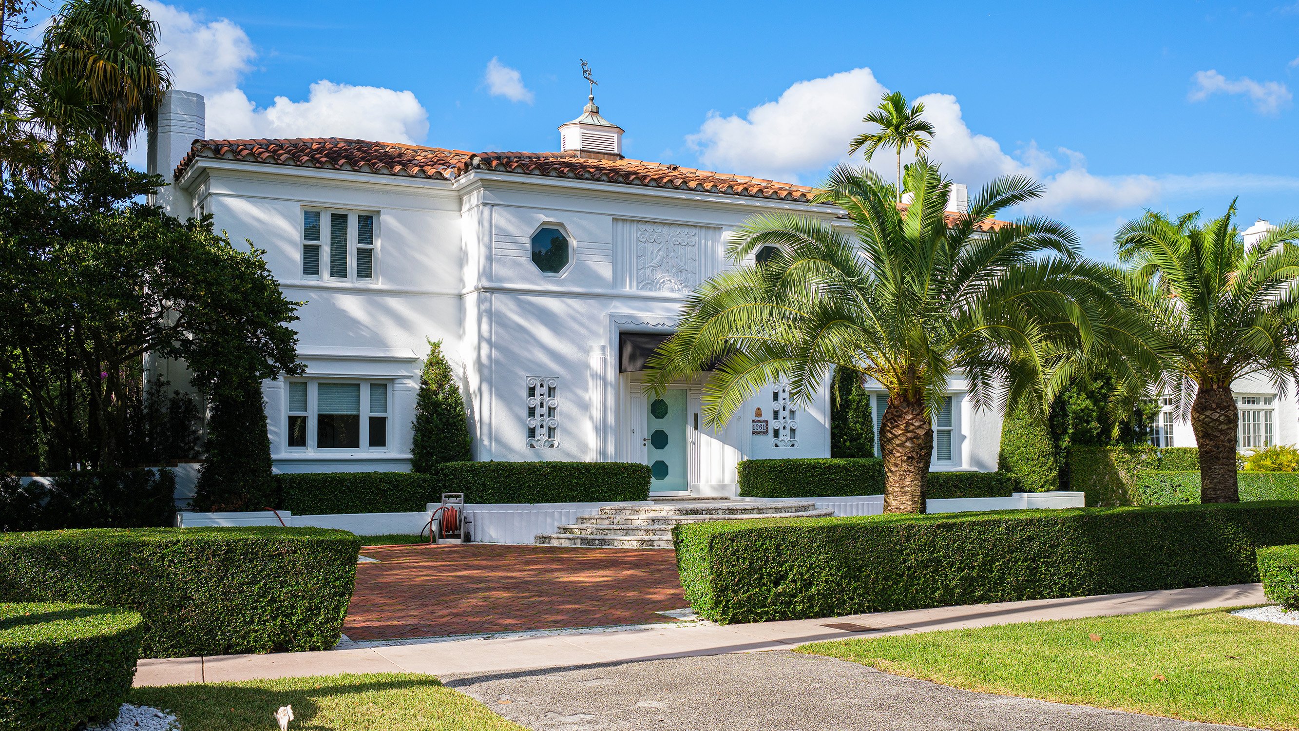 Historic white mansion and gardens in Coral Gables, classic architecture near luxury and ultra luxury condos, with preconstruction and resale opportunities. Featuring garden.