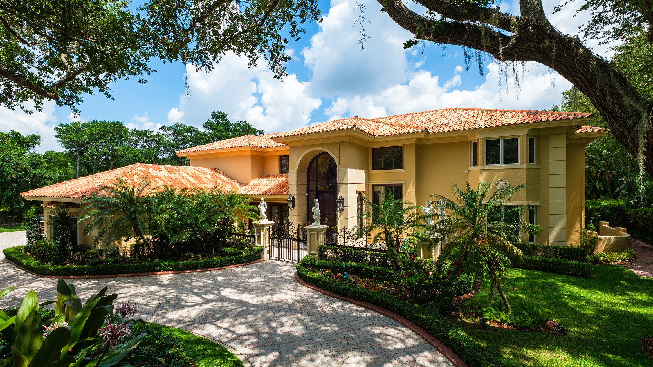 Coral Gables luxury home exterior with landscaped gardens, refined setting near luxury and ultra luxury condos; preconstruction and resale options.