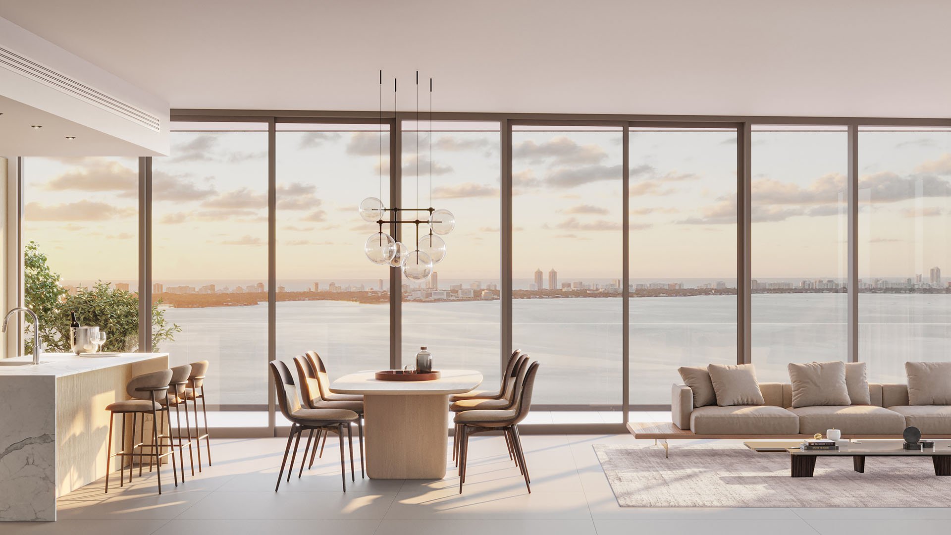 Cove Miami in Miami presents luxury and ultra luxury condos in preconstruction, featuring an open-plan great room with dining, kitchen seating, living space, and expansive bay views through full-width glass.