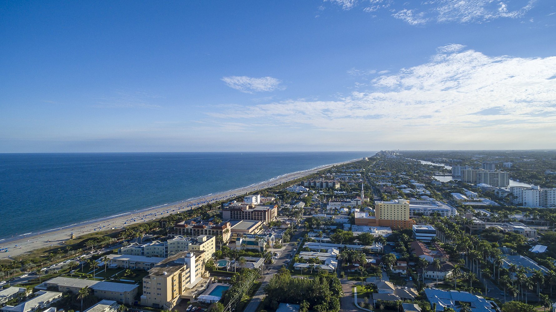 Delray Beach coastal aerial of beachside development and dunes. South Florida market for luxury and ultra luxury condos; preconstruction and resale. Featuring view.
