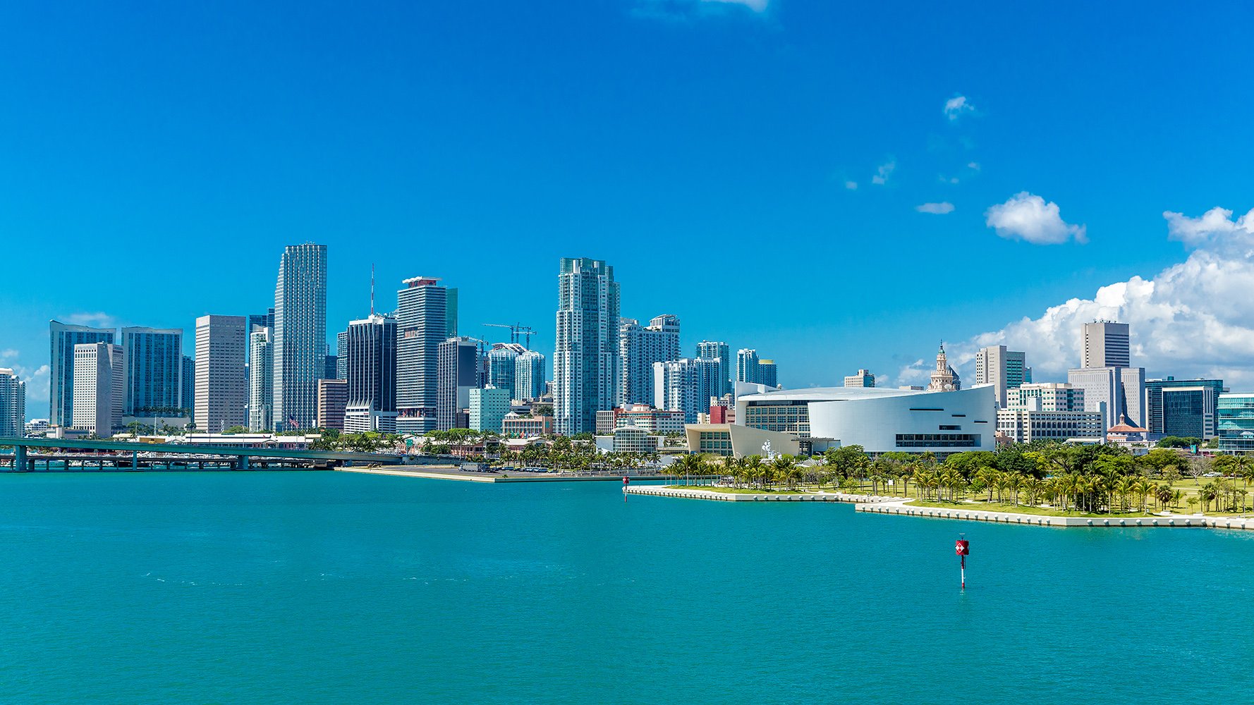 Downtown Miami bay view skyline over Biscayne Bay—sailboats and glass towers in Florida’s urban core; desirable location for luxury and ultra luxury condos, with preconstruction and resale opportunities.