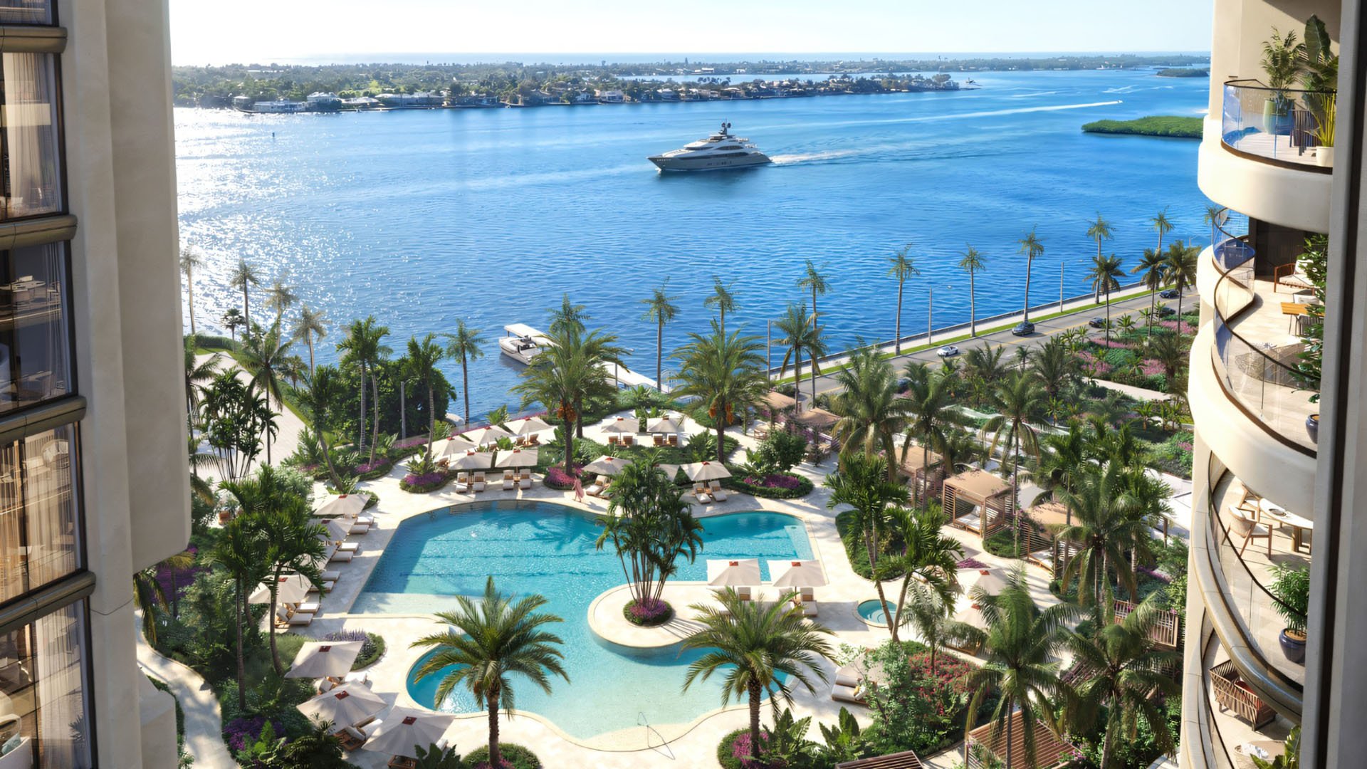 Edgeworth West Palm Beach luxury ultra luxury condos amenity deck overlooking the waterfront, with a resort-style pool, palm-lined terraces, lounge seating, and a marina view with a yacht passing by.
