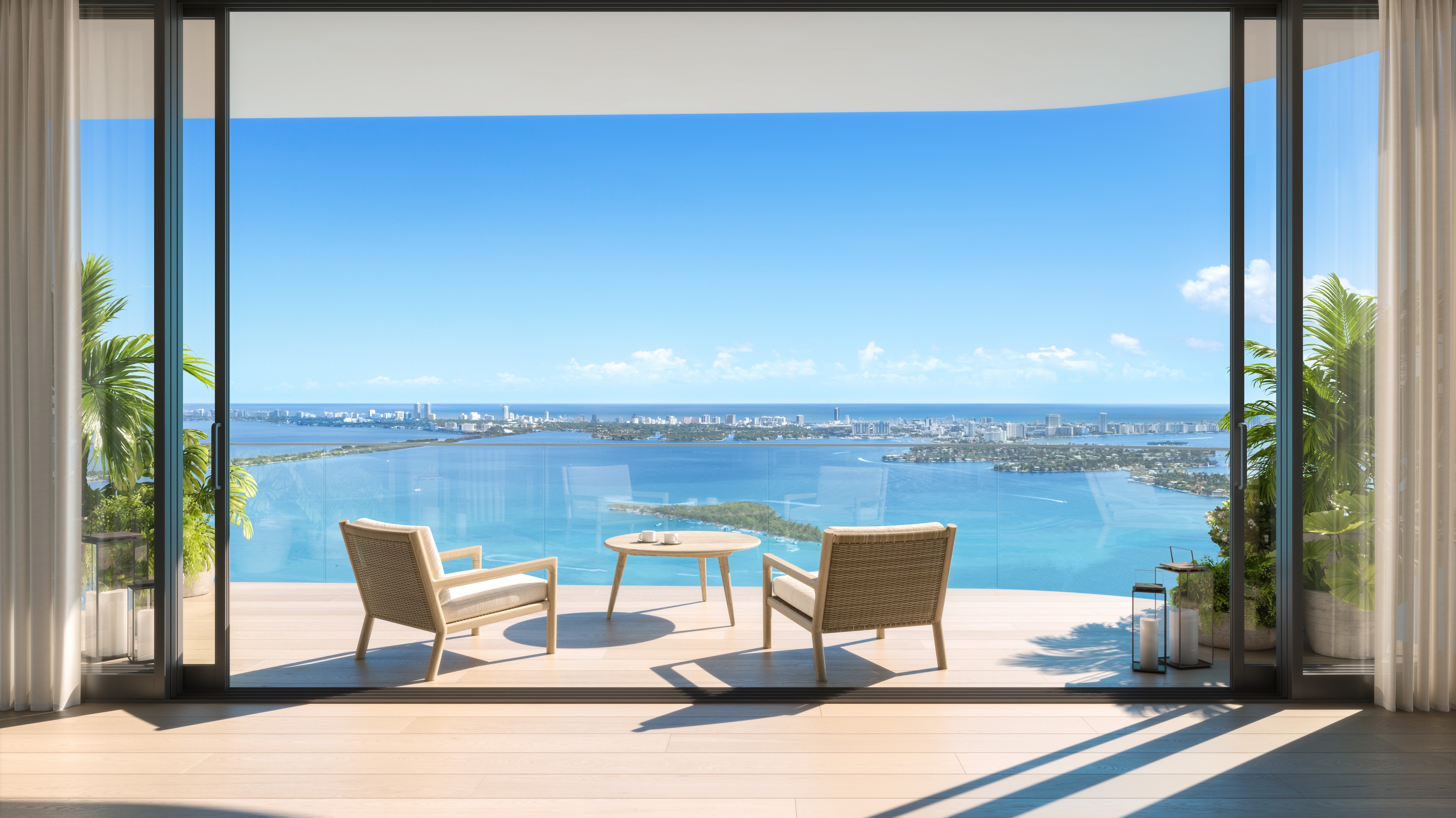 Edition Edgewater, Miami ocean‑view balcony with loungers, indoor‑outdoor living for luxury and ultra luxury condos; preconstruction on Biscayne Bay. Featuring relaxation.