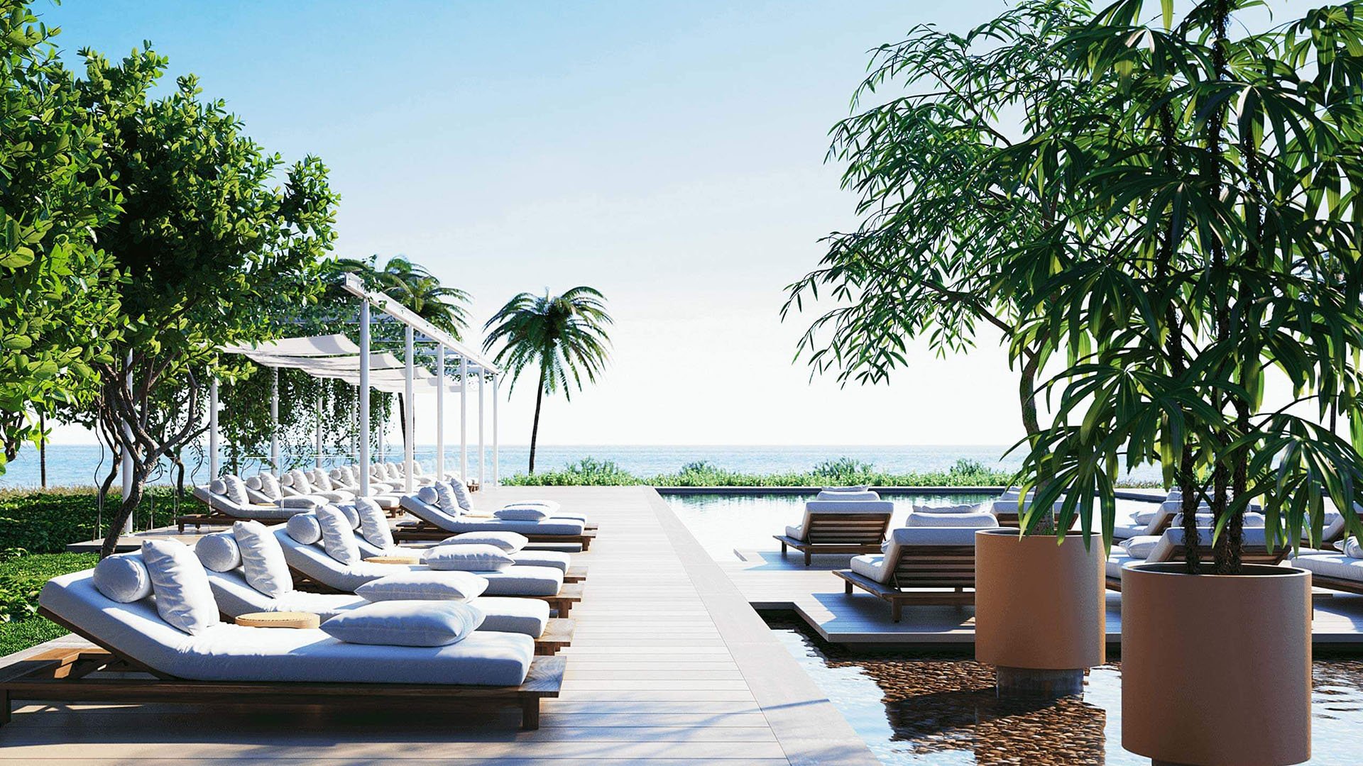 Eighty Seven Park, Miami Beach luxury and ultra luxury condos poolside sun lounger terrace with pergola cabanas, tropical planting, and direct ocean views.