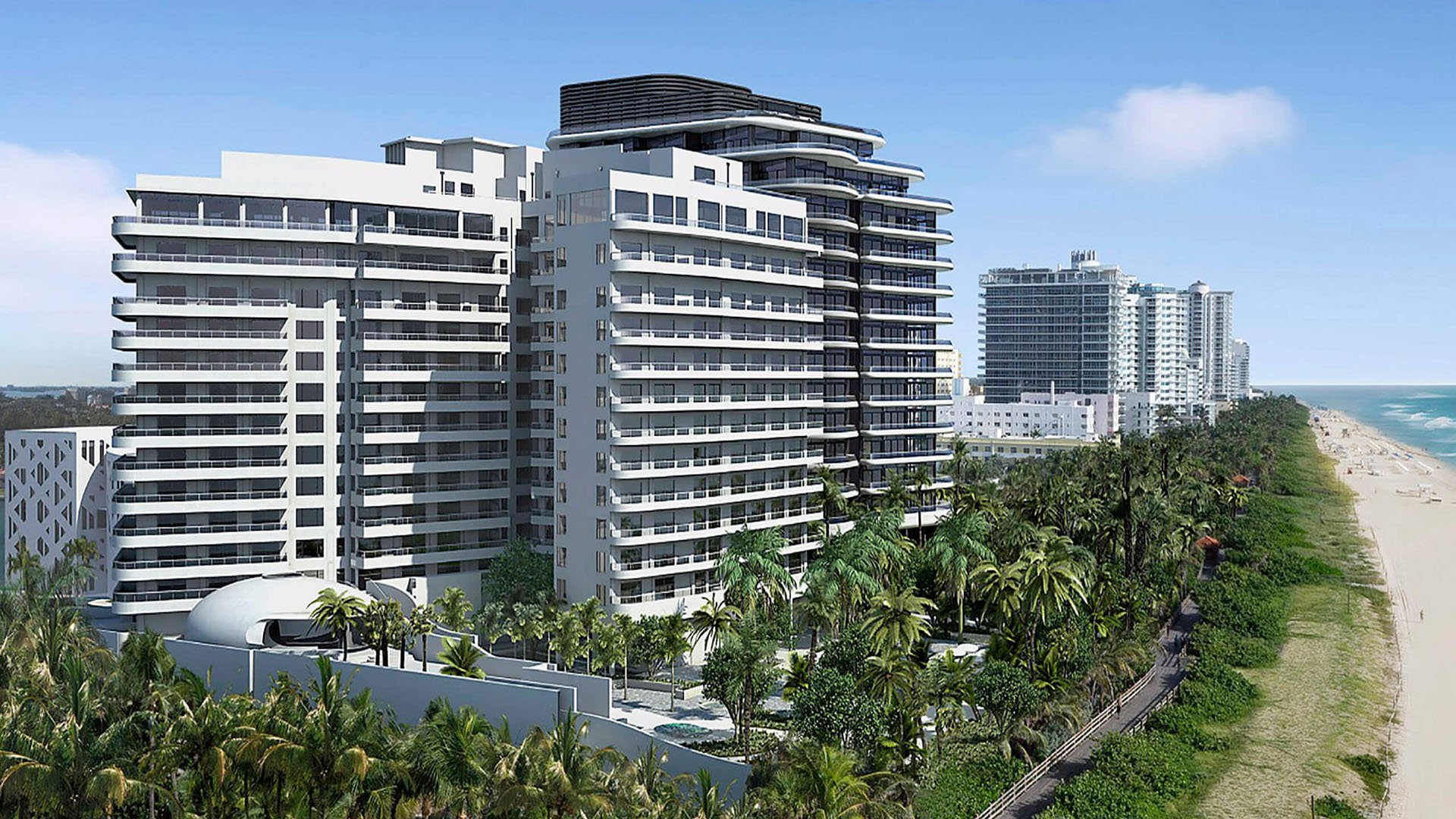 Aerial beachfront view of Faena House in Miami Beach, luxury and ultra luxury condos with a sculptural tower, palm-lined grounds, neighboring buildings, and the Atlantic shoreline.