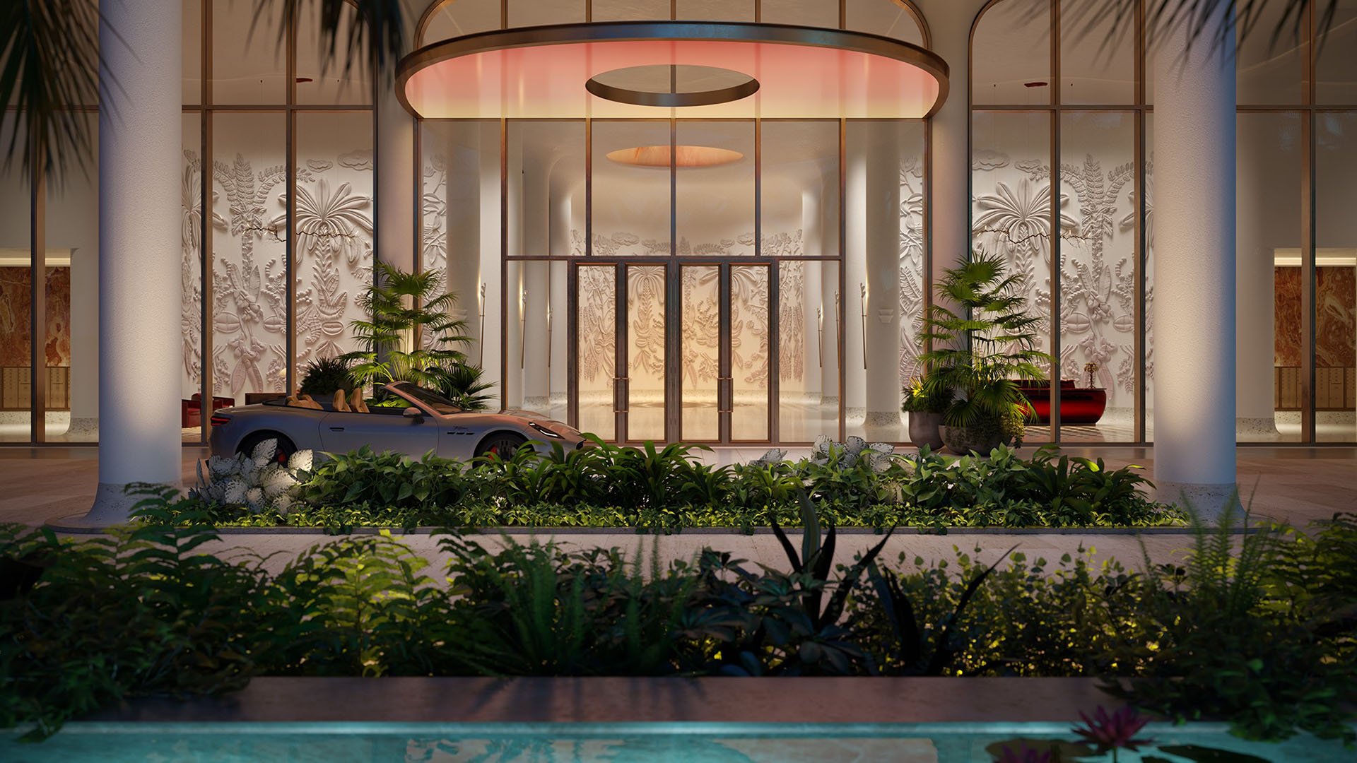 Faena Residences Miami grand arrival porte cochere with glass entrance, warm lighting and tropical landscaping, Downtown Miami. Luxury and ultra luxury preconstruction condos with dramatic curb appeal and valet arrival.